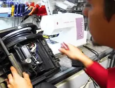 Vacuum repair technician servicing internal components on a workbench in Phoenix, AZ