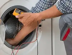 Washing machine repair technician testing a front-load washer with diagnostic tools in Phoenix, AZ