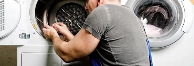 Dryer repair technician fixing a clothes dryer drum in Phoenix, AZ