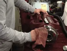 Vacuum repair technician cleaning and servicing a vacuum motor in Phoenix, AZ